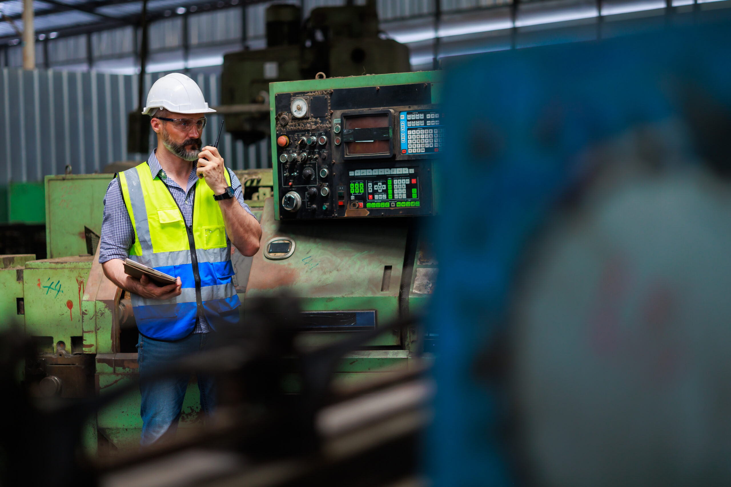 Engineer in factory with walkie talkie