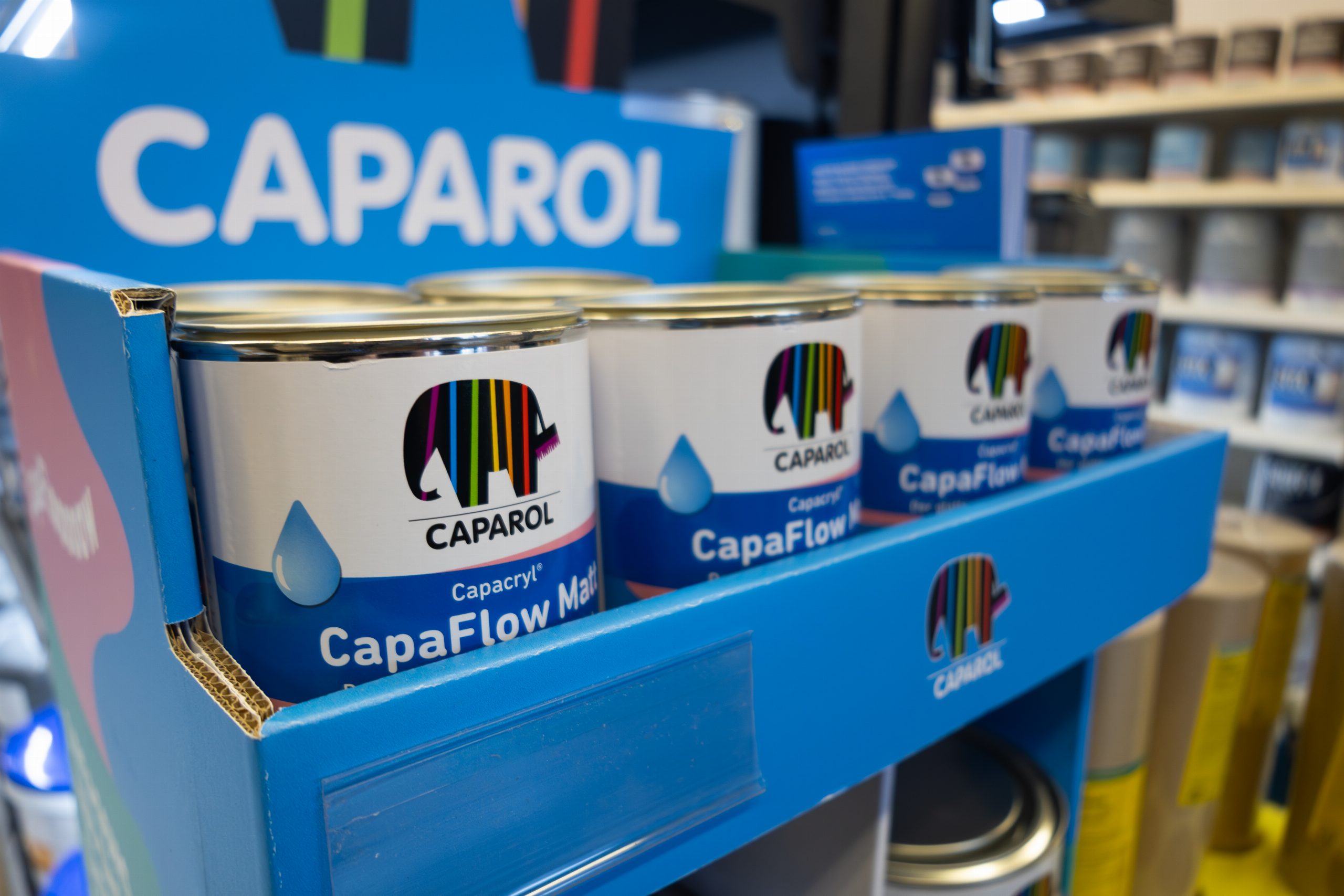 Caparol CapaFlow tins on a branded display stand