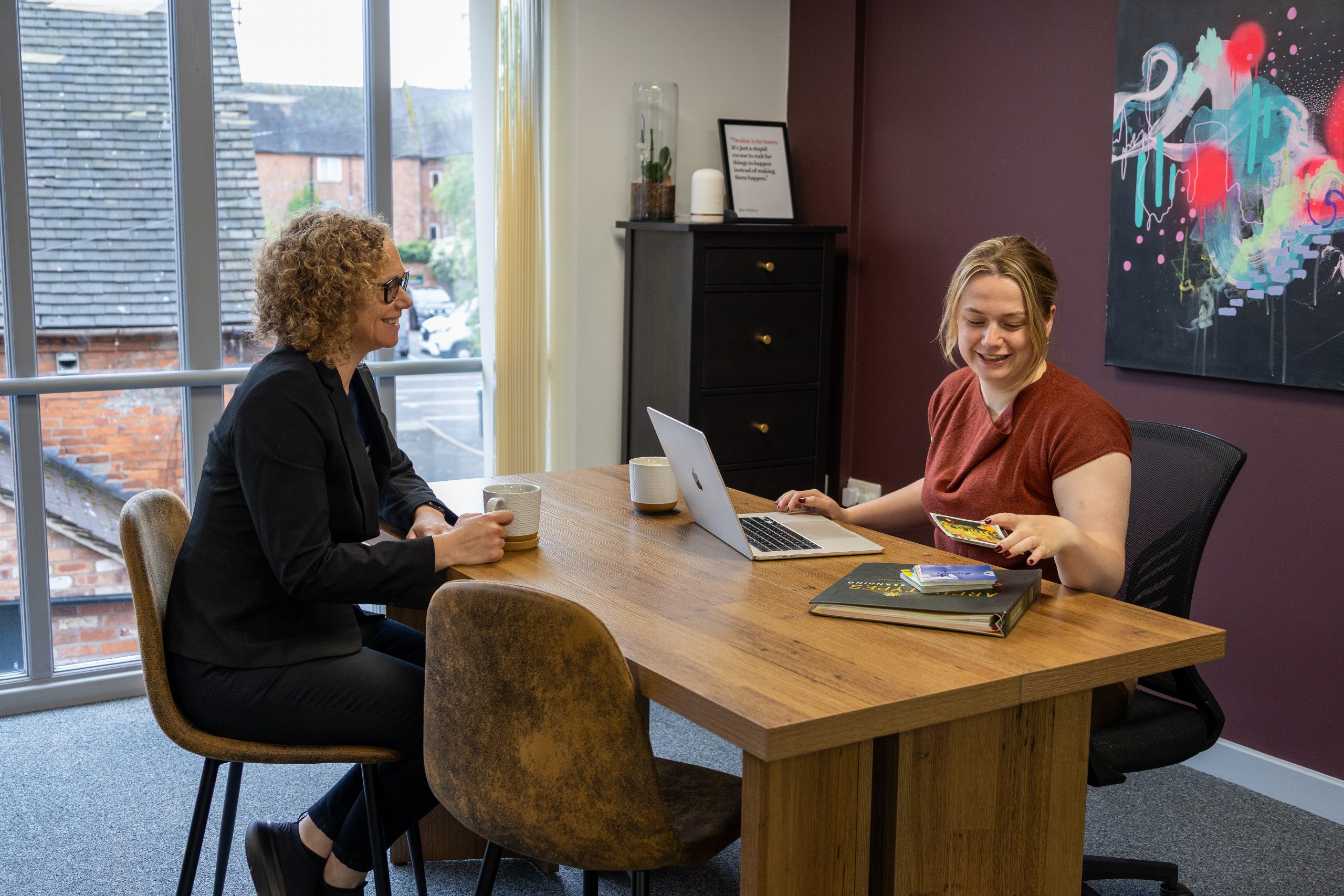 Joanne Tryner and a Big Reputation team member working at a desk