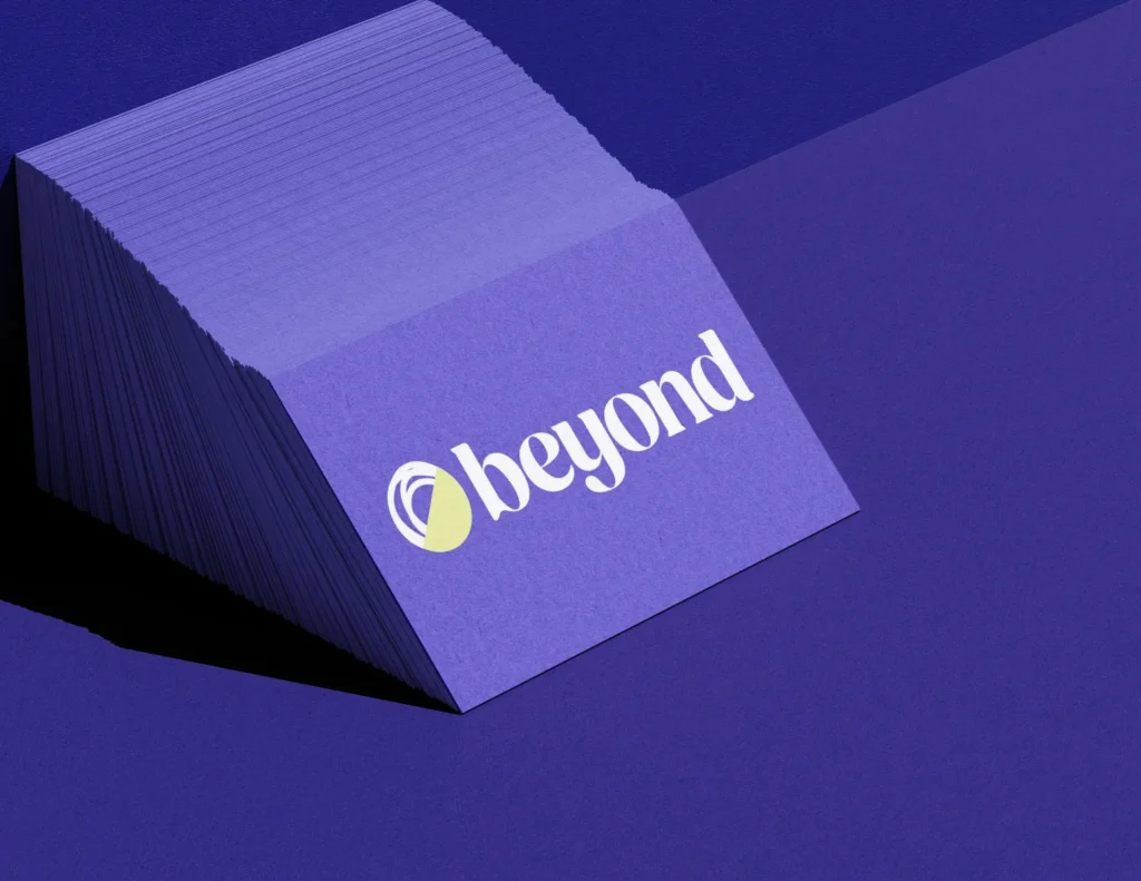A stack of Beyond branded cards in Beyond violet with the beyond logo